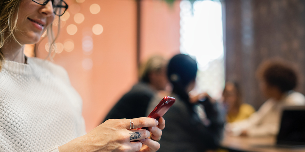 Woman Messaging in Cafe